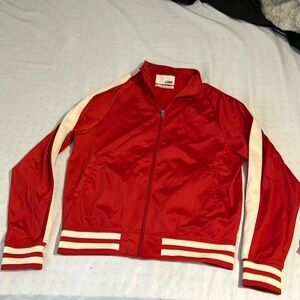 Sports coach type sweater that fits slim.